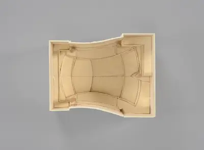 A model of the Walt Disney Concert Hall interior constructed in simple, beige materials schematically illustrates the inwardly curving walls of the room and the arrangement of seats, balconies, and the stage within it. Printed lines suggest the placement of aisles, stairs, and other details.