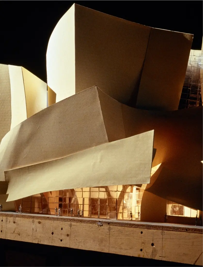 A close-up of an exterior model of Walt Disney Concert Hall is lit internally and externally to show the effects of light and shadow on the building.