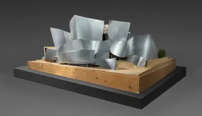 A large, scale model of Walt Disney Concert Hall constructed in wood and foam board is clad with a metal-appearing material to suggest how the building would look upon its completion.