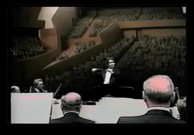 Still from immersive video taken from a model of the Walt Disney Concert Hall interior is spliced with footage from a real-world concert performance to give viewers a sense for how the hall would appear and feel after its completion.