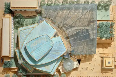 A top-down view onto a detailed model of Walt Disney Concert Hall shows an early design for the building and its immediate environment, including scale figurines, cars, and landscaping.