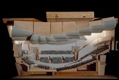 A scale model in wood and foam board represents an interior section of Walt Disney Concert Hall, with artificial lighting streaming in from two sides