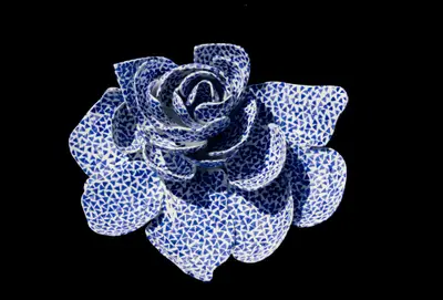 A model of a fountain takes the form of a rose, clad in white and blue tiles