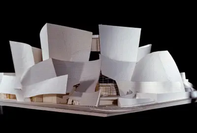 A eye-level view of a model of Walt Disney Concert Hall constructed in printed paper, foam board, and wood suggests the dynamic appearance of the building, with the facade cladding outlined in printed lines.