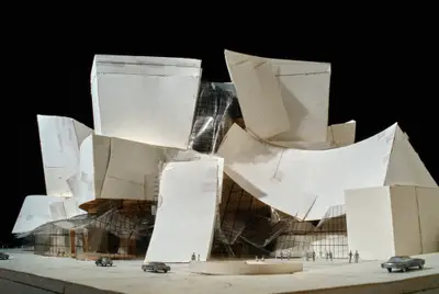 A model of the façade of Walt Disney Concert Hall is made of paper, acrylic, and tape. The model is roughly constructed, with its seams and folds visible.