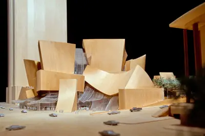An eye-level view of a highly refined model of Walt Disney Concert Hall constructed in finished wood and acrylic elegantly suggests the dynamic form of the building. Scale cars, trees, and figurines afford realism.