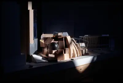 A dramatically lit, pedestrian's-eye view of a model of Walt Disney Concert Hall constructed in wood and acrylic suggests the dynamic appearance of the building. Scale cars afford realism.