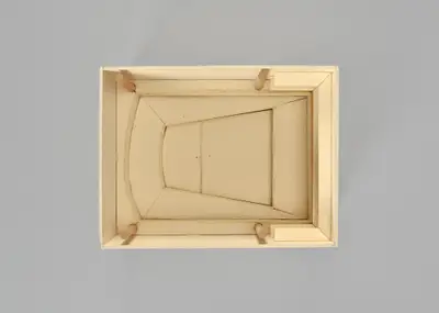 A model of the Walt Disney Concert Hall interior constructed in simple, beige materials schematically illustrates the dimensions of the rectangular room and the arrangement of seats and the stage within it.