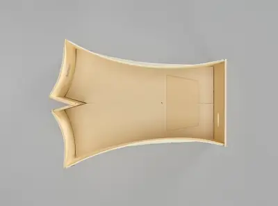 A model of the Walt Disney Concert Hall interior constructed in simple, beige materials schematically illustrates the curving walls of the room and the placement of the stage within it.