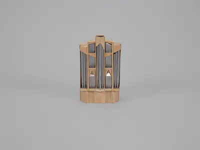 A scale model of an organ constructed in light-colored wood with pipes of various lengths painted silver and leafed with metal foil